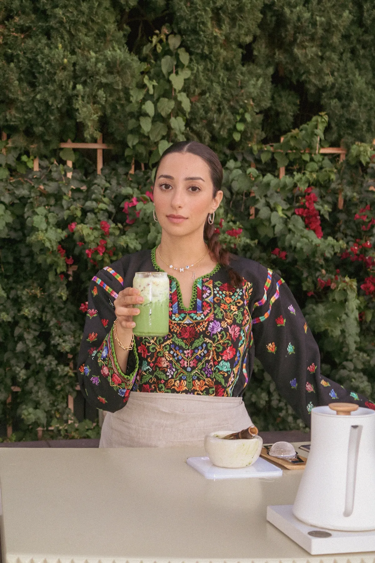 Matcha Minka founder presenting a signature iced matcha drink