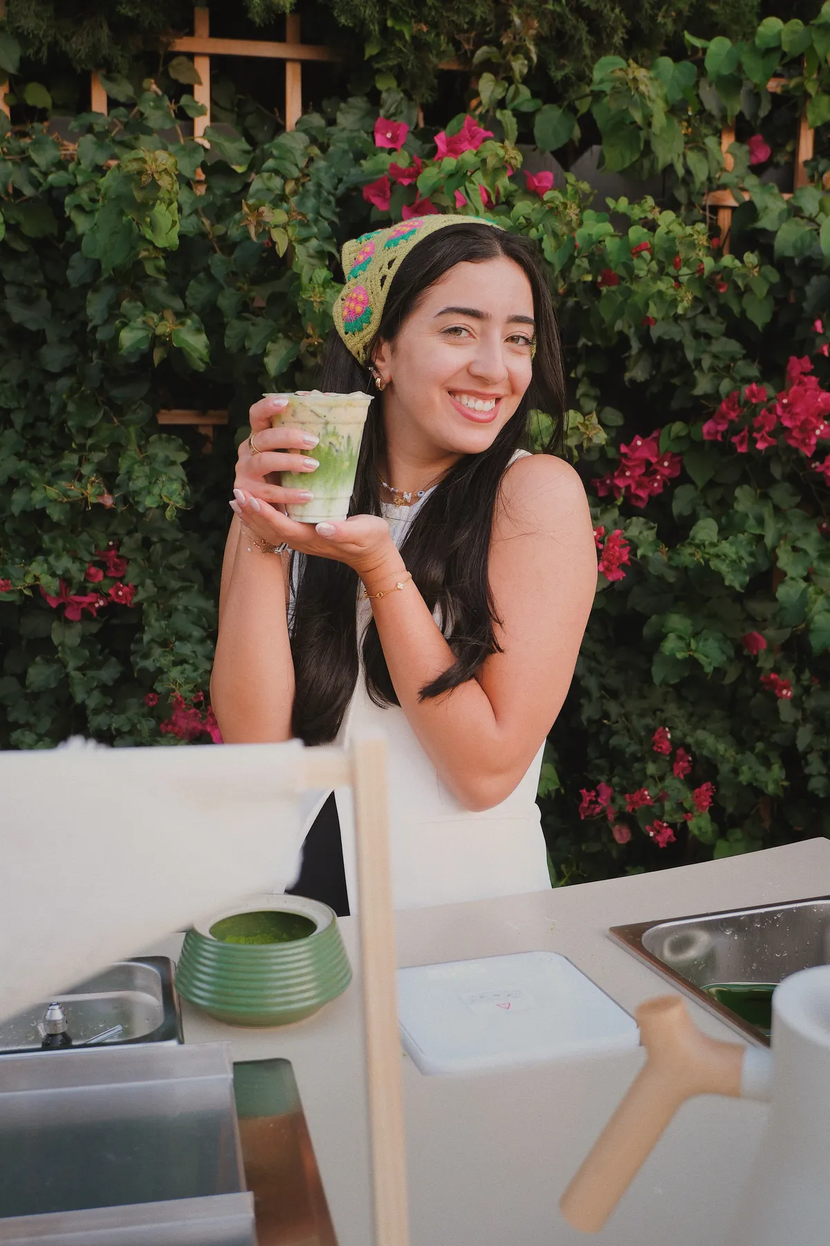 Matcha Minka artisan smiling at the cart with an iced matcha drink